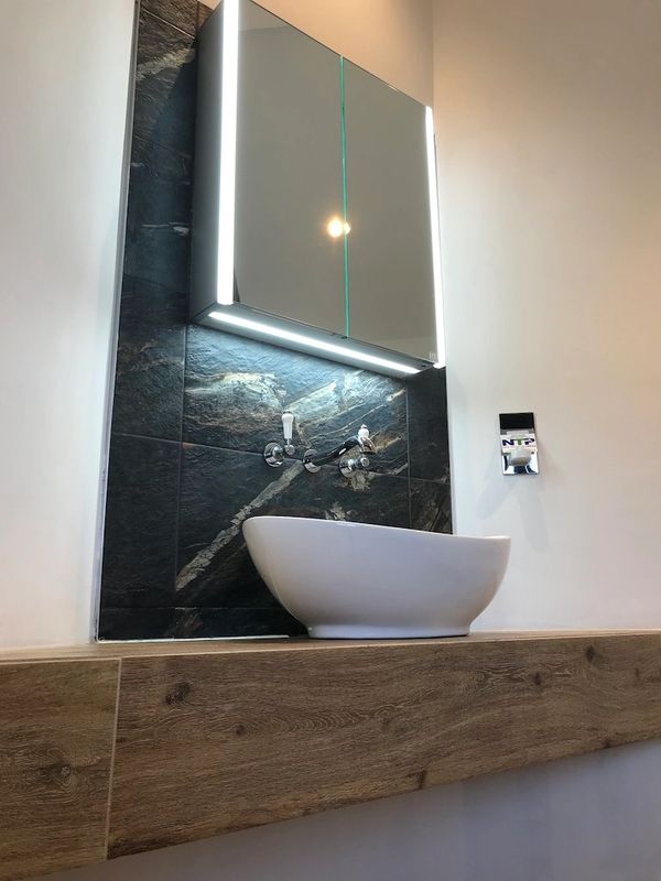 Beautiful countertop basin, Chrome wall mounted basin taps enhanced by LED mirror lighting.
