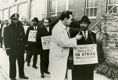 Rev. Martin Luther King and Rev. Ralph Abernathy join picket line in support of striking workers. 