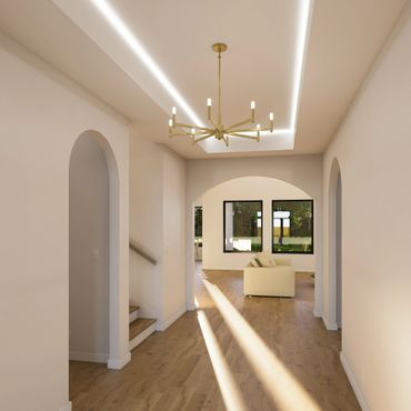 Modern hallway with wooden floors, archways, and a gold chandelier.