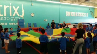children playing with a colourful sheet