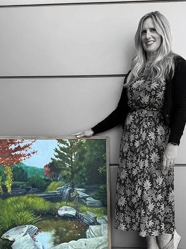 Artist Mary Lanka with her oil painting of Frederik Meijer Gardens entitled "A Glimpse of Things to