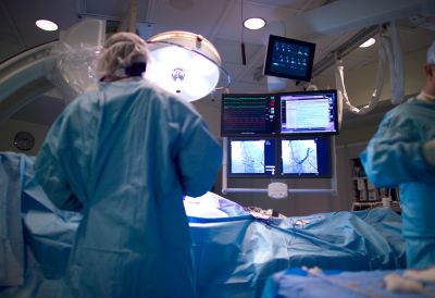 Doctors performing surgery in an operating room.