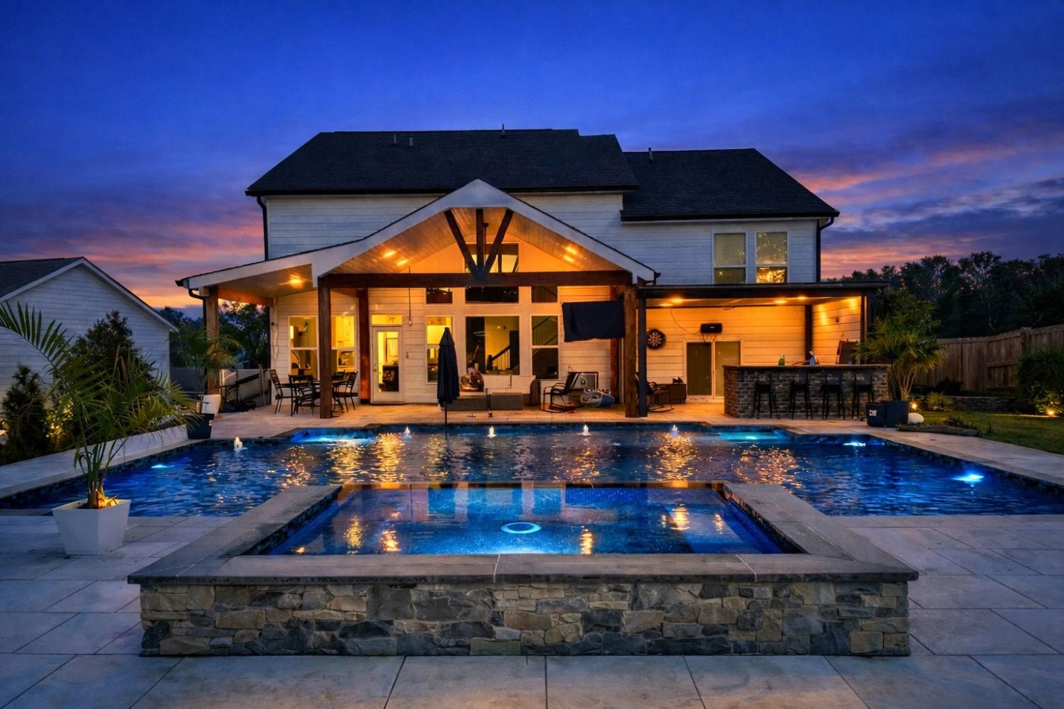Custom backyard swimming pool with LED pool lights and natural stone spa, Atlanta, Ga.