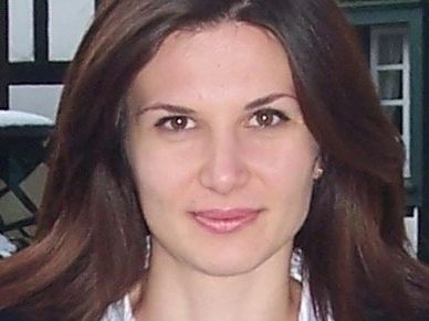 Portrait of a woman with long brown hair.