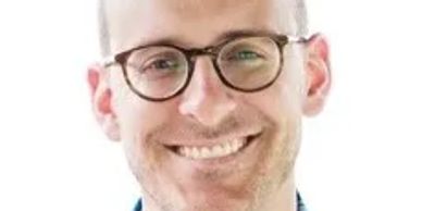 Smiling man wearing glasses.