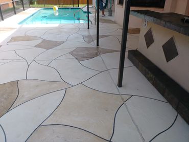 A pool deck with a stain design