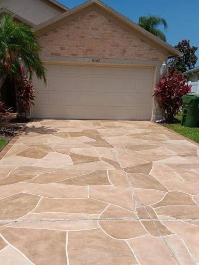Stone-patterned driveway in front of a garage.