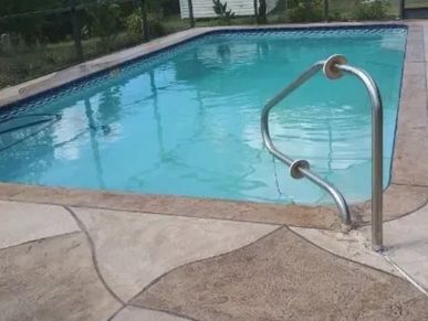 Swimming pool with a distorted handrail.
