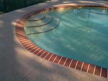 A pool deck with a custom border