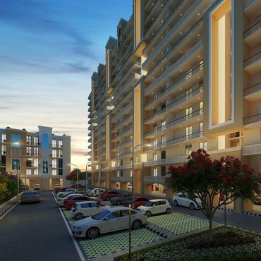 Modern apartment complex with ample parking and evening lighting.