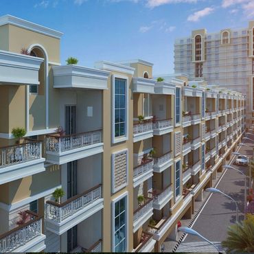 Modern residential building with balconies and street view under clear sky.