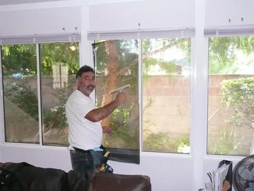 Man cleaning room window glasses