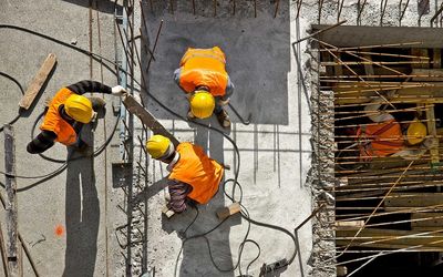 3 workers laying Re-Bar on a construction site