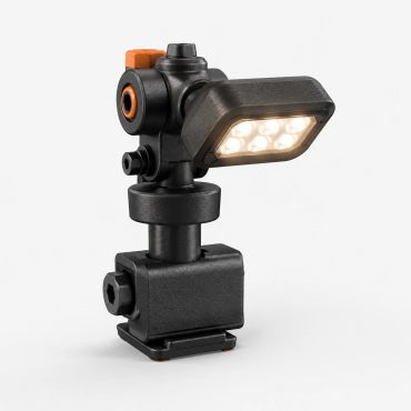 Compact black LED work light with adjustable joints and orange accents.