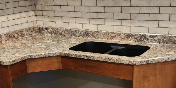 Corner kitchen countertop with a black sink.