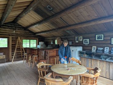 woman cleaning wood table and chairs