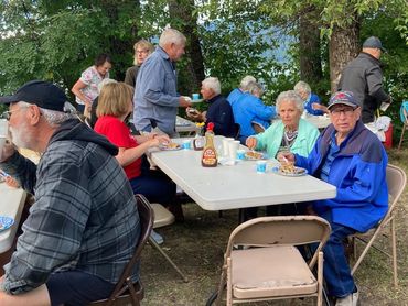 people seated at table, eating huckleberry pancakes
