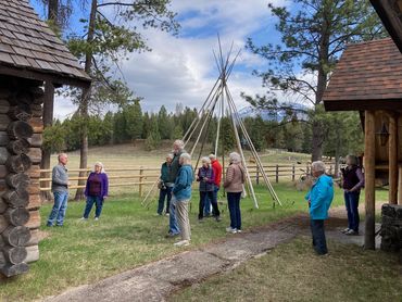 people gathered outdoor, tepee in background