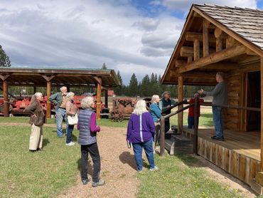 people outdoor, man on porch, speaking to the group