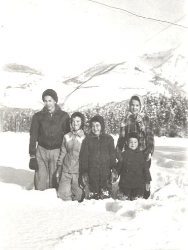 group of people in winter, snow covered mountains