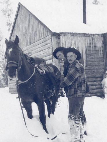 two men and horse during winter