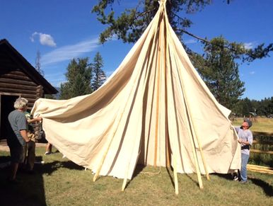 two men assembling tipi
