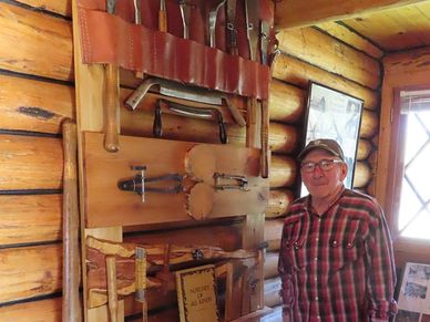 man with log buidling tools