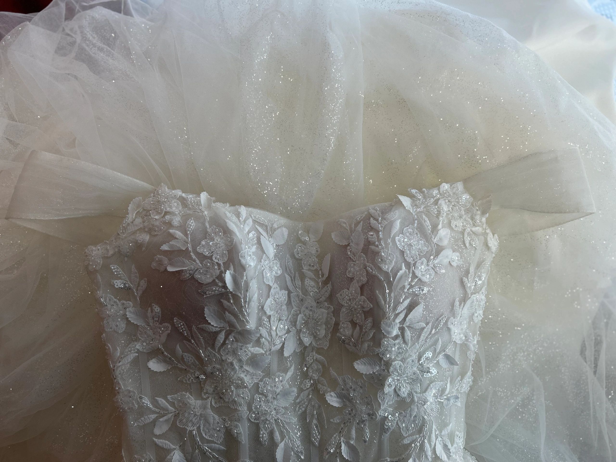 Bridal Gown that has custom sleeves and points raised on the neckline. Custom neckline alterations