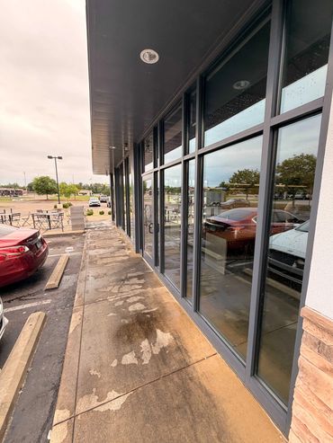 Clean commercial storefront glass after professional window washing in Opelika, AL