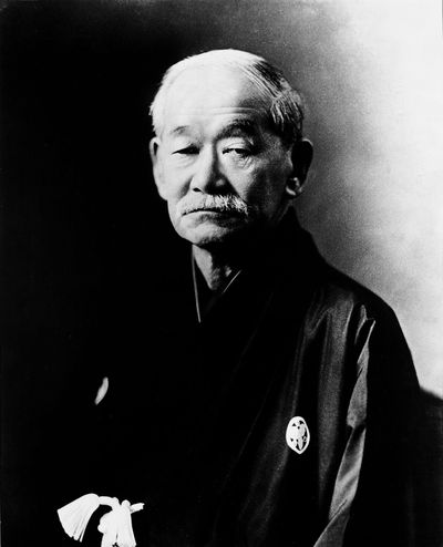 Portrait of an elderly Japanese man in traditional attire.