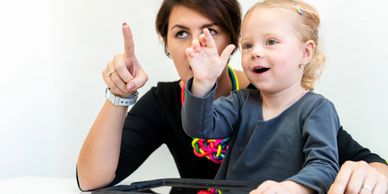 Therapist teaching a child communication skills.