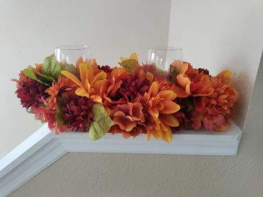 Two glass centerpiece made with using a  pool noodle as its base. Added faux flowers to embellish it