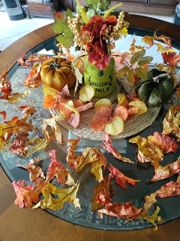 Coffee table Fall harvest pumpkins decor with surrounding fall leaves
