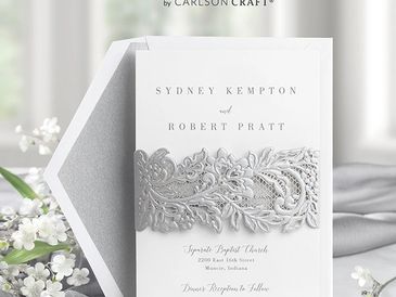 Elegant white wedding invitation with silver lace design.