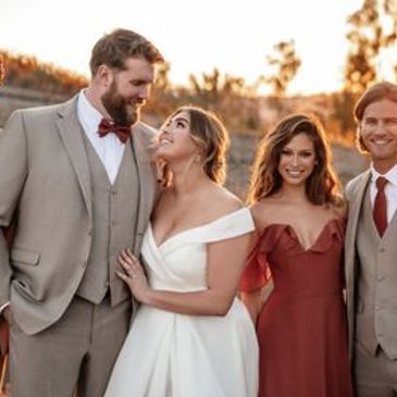 Happy couple and friends at outdoor wedding.