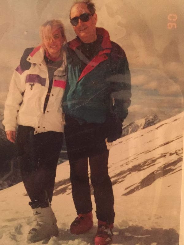 Father and daughter helicopter skiing on adventure experience