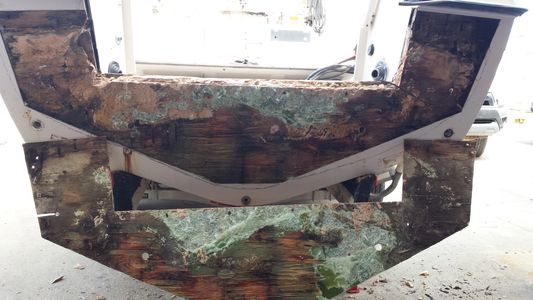 Taking off outer skin to remove all wood from transom before pouring in Seacast™. 