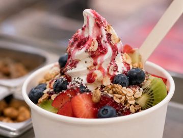 Frozen yogurt with fresh fruit and granola.