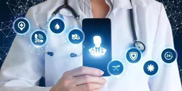 Digital health symbolized as happening through a smartphone held by a doctor.