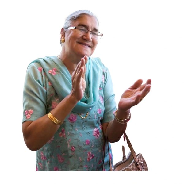 Elderly woman clapping and smiling.