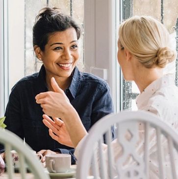 Two women discussing with each other