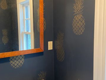 We accented this client's love of the pineapple as a symbol for "welcome" in her powder room.
