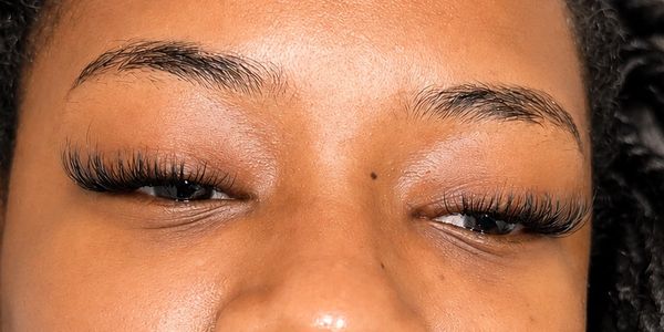 Close-up of eyes with long, thick eyelash extensions.