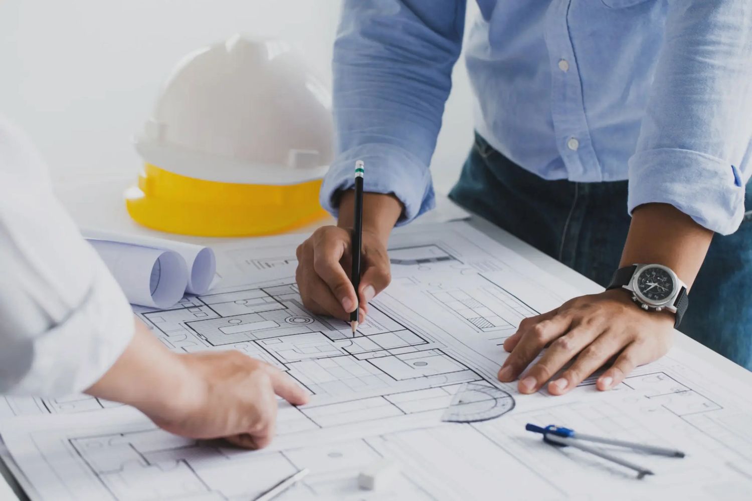 Architects reviewing blueprints and plans at work.