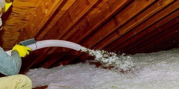 Insulation being blown into attic space.