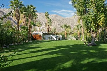 Palm Springs vacation rental with lush green and botanical gardens
