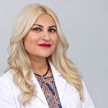 Confident female doctor with blonde hair and white coat.