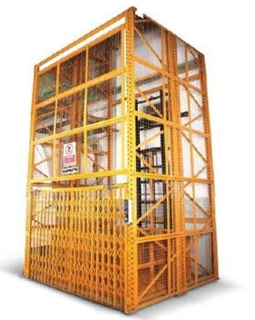 Industrial freight elevator with yellow safety cage and gate.