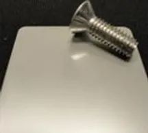 Screw on a metal plate blurry image