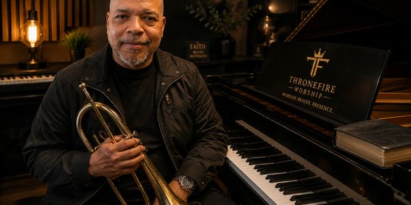 Man holding trumpet sitting by a piano with 'Thronefire Worship' logo.